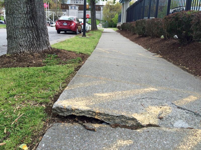 Damaged sidewalk before repair